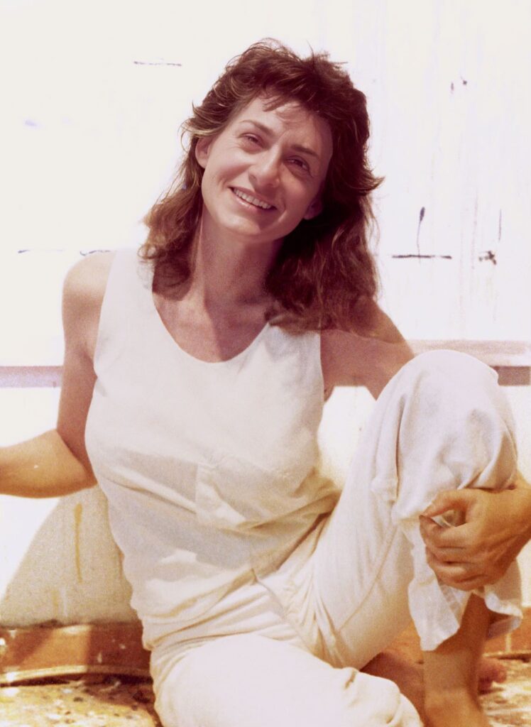 Lynda in her studio at Cornell wearing white.